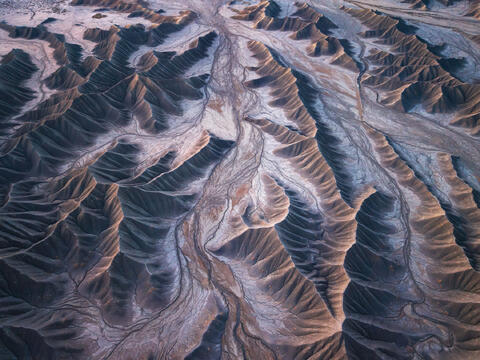 Soft light highlighting the layered ridges and subtle textures of the Utah badlands.