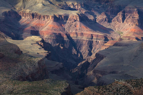 Afternoon light rakes across the a section of the south rim in Grand Canyon National Park.