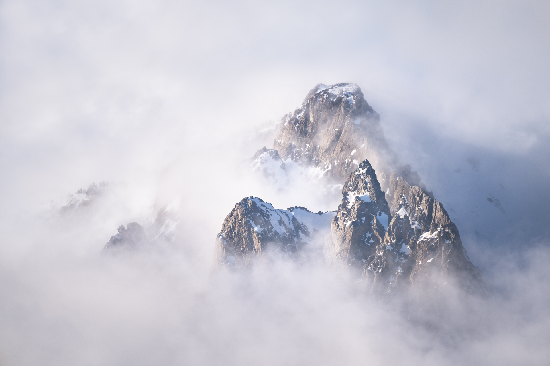 Sierra Shroud The mountains at June Lake reveal themselves after a shroud of clouds begin to elevate during sunrise.